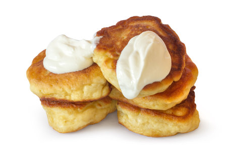 Thick homemade pancakes with sour cream on a white background. Fresh natural pancakes are isolated.の写真素材