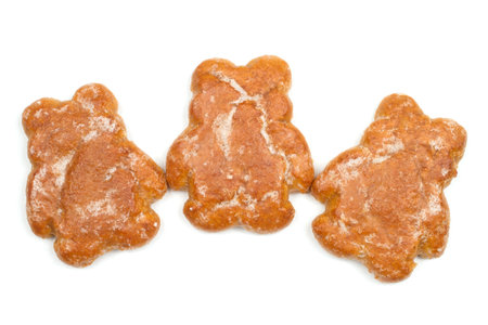 Three gingerbread in the shape of bear cubs on a white background. Sweet cookies.の写真素材
