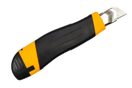Modern utility knife isolated on white background. Close-up of a box cutter.