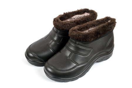Fur galoshes on a white background. Winter autumn shoes close-up.