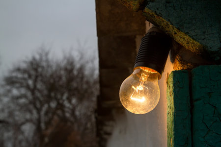 An old electric incandescent lamp for street lighting. Lighting of the village yard.の写真素材