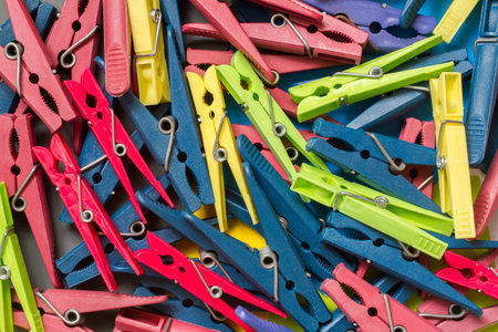 Lots of colorful plastic clothespins. The texture of clothespins.