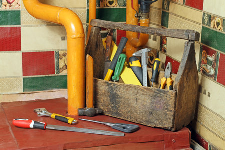 Tools in an old wooden box for home repairs. Maintenance tools.
