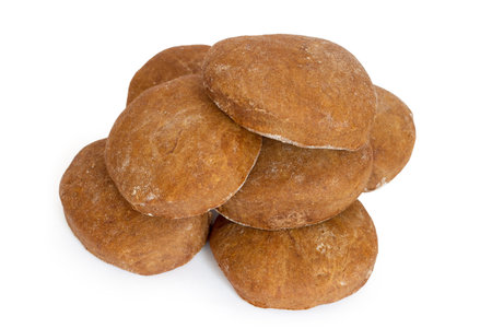 A pile of homemade chocolate gingerbread on a white background. Brown homemade cookies.の写真素材