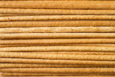 Texture of horizontal breadsticks. Thin long biscuits, straws.の写真素材
