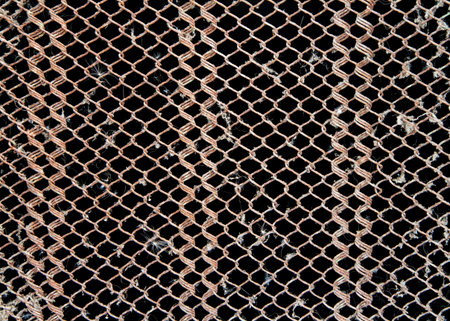 Rusty iron mesh on a black background. Dirty iron grate.