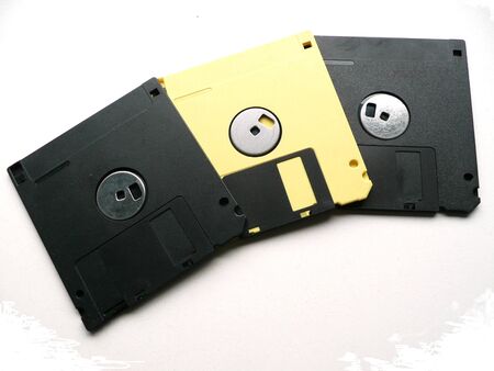 3 old floppy discs, 2 black 1 yellow