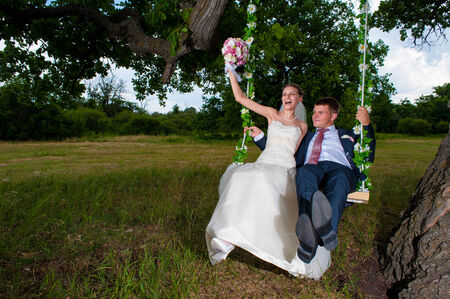 Groom and  bride  on swingの写真素材