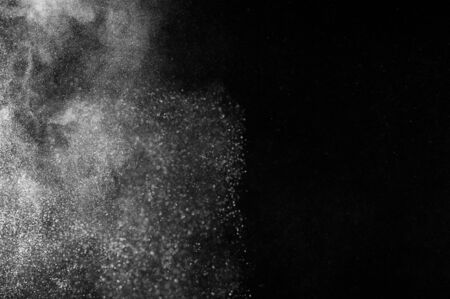 Abstract white powder explosion  on black backgroundの写真素材