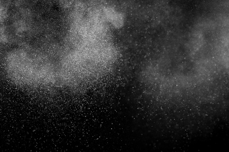 abstract white powder explosion  on black backgroundの写真素材