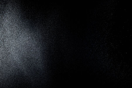 abstract white powder explosion  on black backgroundの写真素材