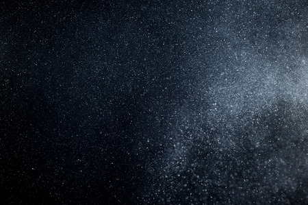abstract white powder explosion  on black backgroundの写真素材