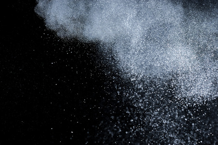 abstract white powder explosion  on black backgroundの写真素材