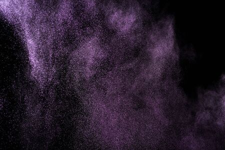Abstract purple powder explosion on black background.の写真素材