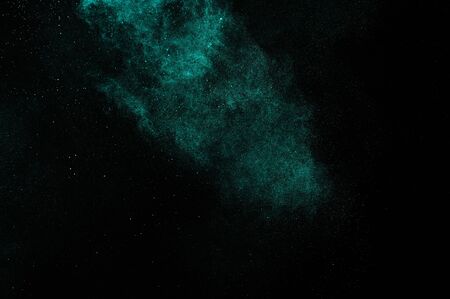 Abstract aquamarine powder explosion on black background.の写真素材