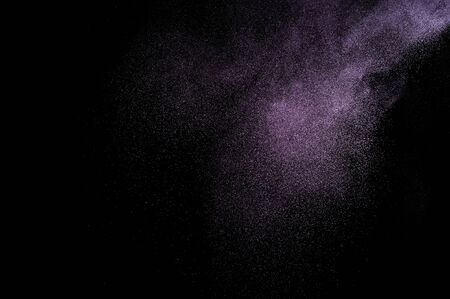 Abstract purple powder explosion on black background.