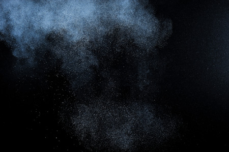 abstract white powder explosion  on black backgroundの写真素材