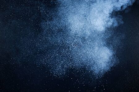 abstract white powder explosion  on black backgroundの写真素材