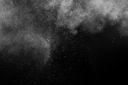 abstract white dust explosion  on a black background. abstract white powder explosion  on a black background.の写真素材