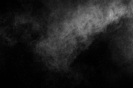 abstract white dust explosion on a black backgroundの写真素材