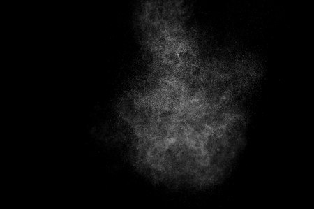 abstract splashes of water on a black background. splashes of milk. abstract spray of water. abstract rain. shower water drops.  white dust explosion. abstract texture. abstract black background.の写真素材