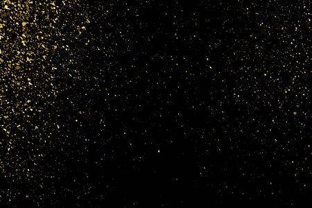 Gold glitter texture on a black background. Holiday background. Golden explosion of confetti. Golden grainy abstract  texture on a black  background. Design element. のイラスト素材