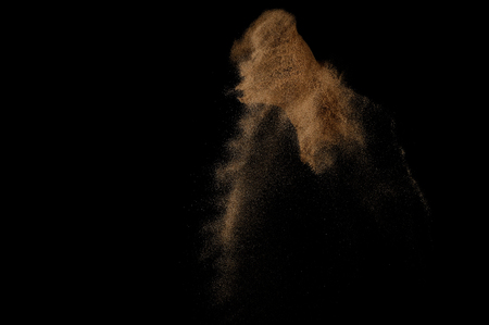 Sandy explosion isolated on black background. Abstract sand cloud.の写真素材