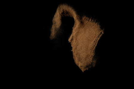 Sandy explosion isolated on black background. Abstract sand cloud.の写真素材