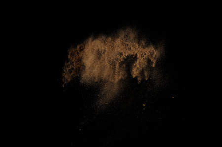Sandy explosion isolated on black background. Abstract sand cloud.の写真素材