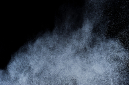 White powder explosion on black background. Abstract white dust texture.の写真素材