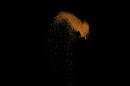 Sandy explosion isolated on black background. Abstract sand cloud.の写真素材