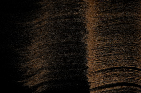 Sandy wave isolated on black background. Abstract sand dune.の写真素材