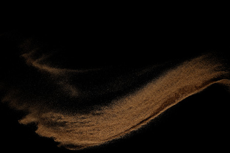 Sandy wave isolated on black background. Abstract sand dune.の写真素材