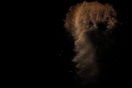 Sandy explosion isolated on black background. Abstract sand cloud.の写真素材