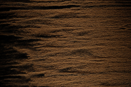 Sandy wave isolated on black background. Abstract sand dune.の写真素材