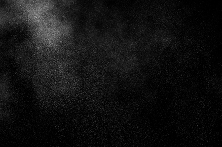 White powder explosion on black background. Abstract white dust texture.の写真素材