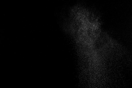 White powder explosion on black background. Abstract white dust texture.の写真素材