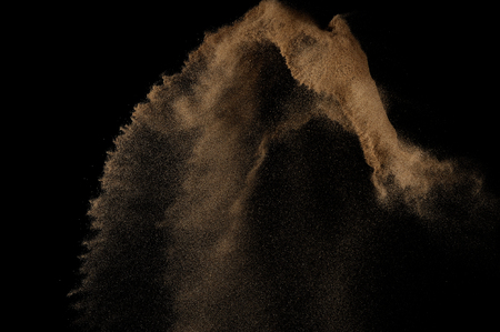 Sandy explosion isolated on black background. Abstract sand cloud.の写真素材
