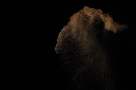 Sandy explosion isolated on black background. Abstract sand cloud.の写真素材
