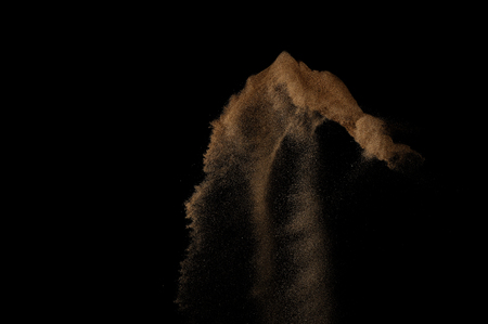 Sandy explosion isolated on black background. Abstract sand cloud.の写真素材