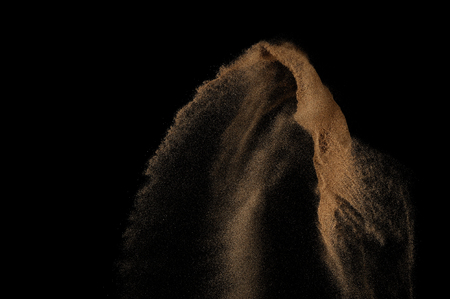 Sandy explosion isolated on black background. Abstract sand cloud.の写真素材