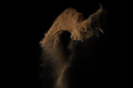 Sandy explosion isolated on black background. Abstract sand cloud.の写真素材