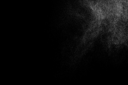 Abstract splashes of water on black background. Freeze motion of white particles. Rain, snow overlay texture.の写真素材