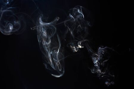 Freeze motion of smoke on black background.  Abstract vape clouds.の写真素材