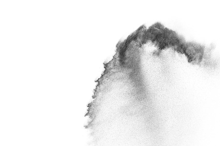 Black particles explosion isolated on white background.  Abstract dust overlay texture.の写真素材