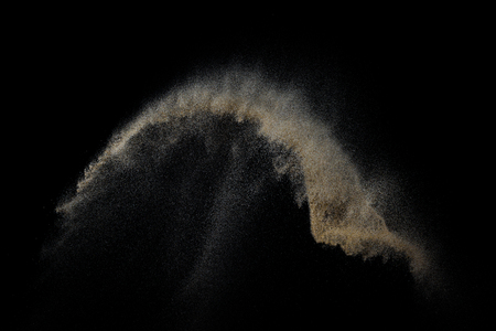 Sandy explosion isolated on black background. Abstract particles cloud. Texture element for design.の写真素材