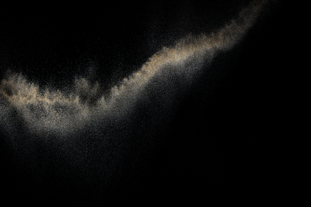 Sandy explosion isolated on black background. Abstract particles cloud. Texture element for design.の写真素材