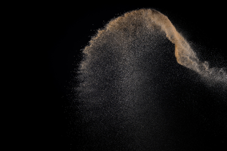 Sandy explosion isolated on black background. Abstract particles cloud. Texture element for design.の写真素材