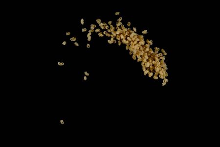 Flying pasta isolated on black background. Abstract macaroni falling.の写真素材