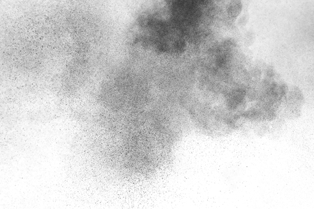Black particles explosion isolated on white background.  Abstract dust overlay texture.の写真素材